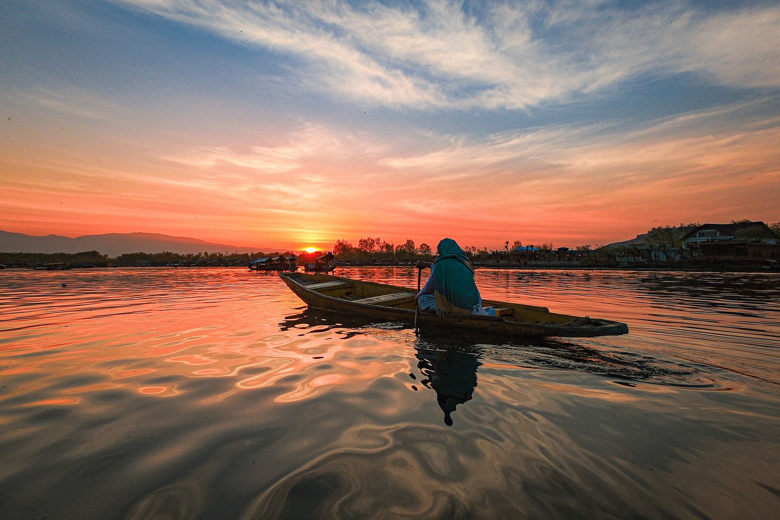 Dal Lake at sunset with shikaras